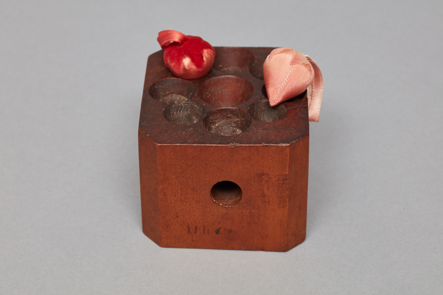 A wooden box with a flower in it.