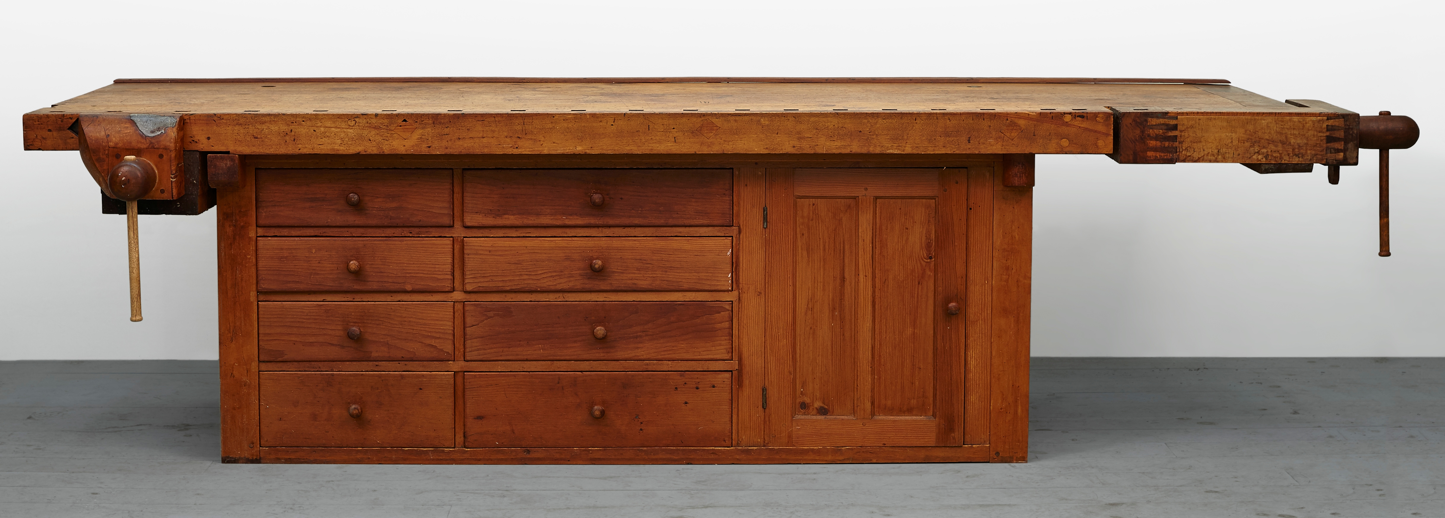 A wooden workbench with drawers on top.