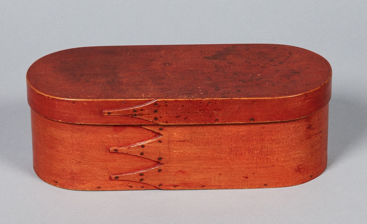 A red wooden box with a lid.