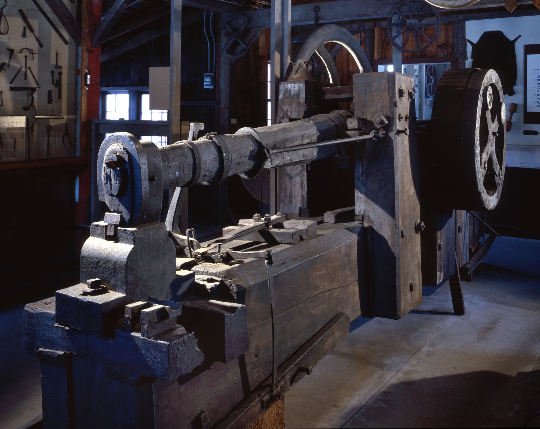 A machine with a wheel on it in a room.