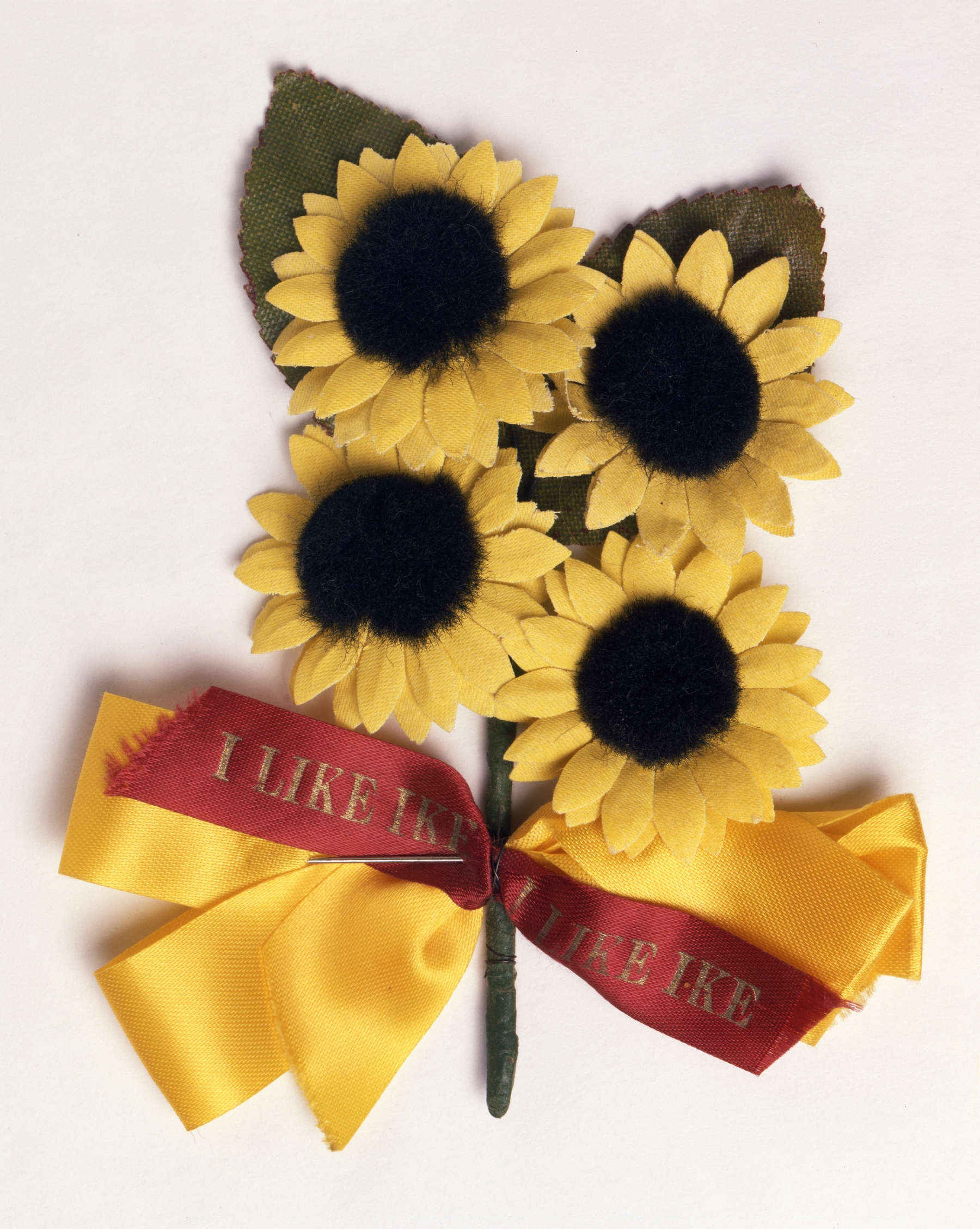 A bouquet of sunflowers with a red ribbon.