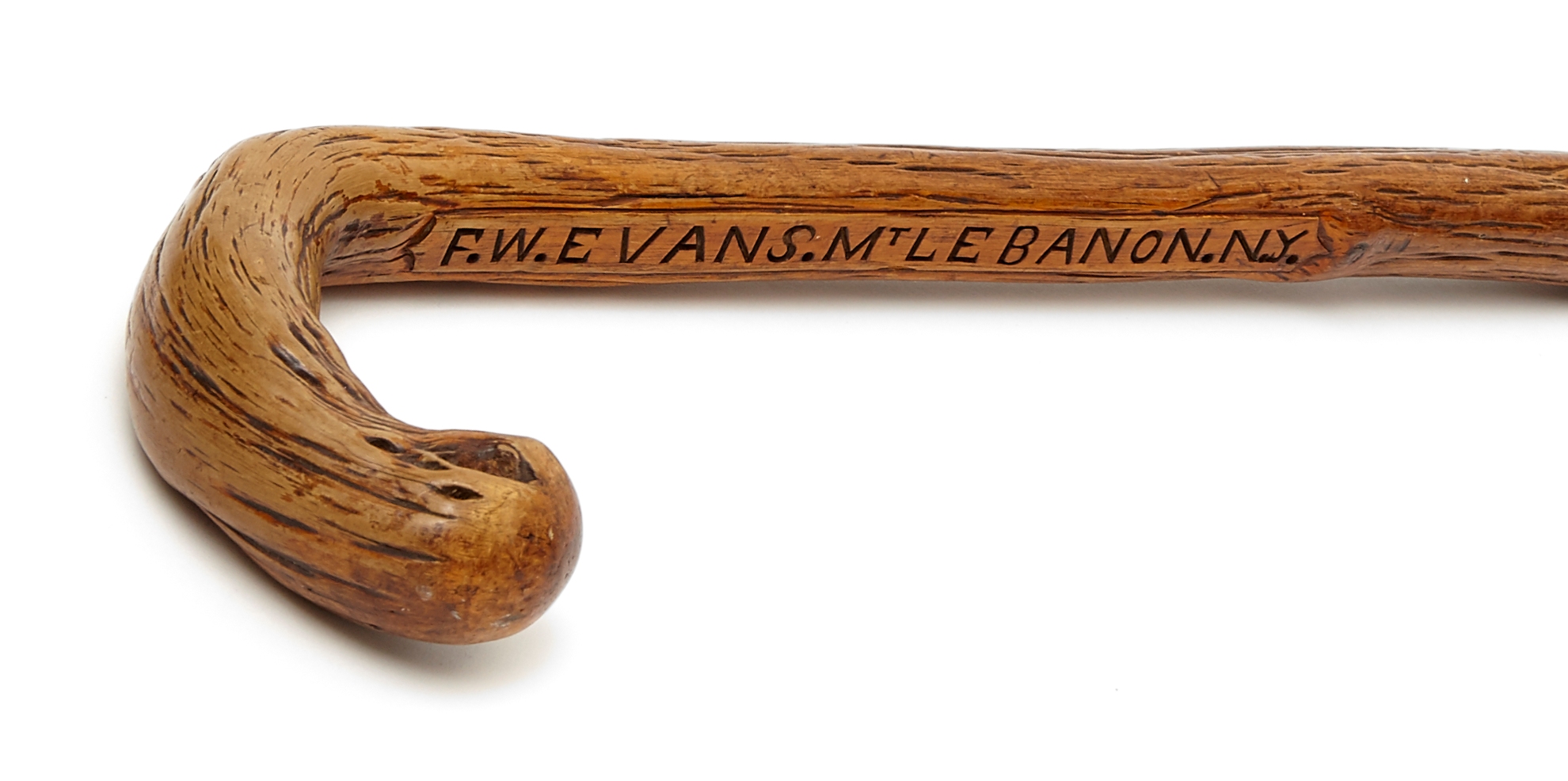 A wooden cane with the words'five van cleef and van cleef'engraved on it.