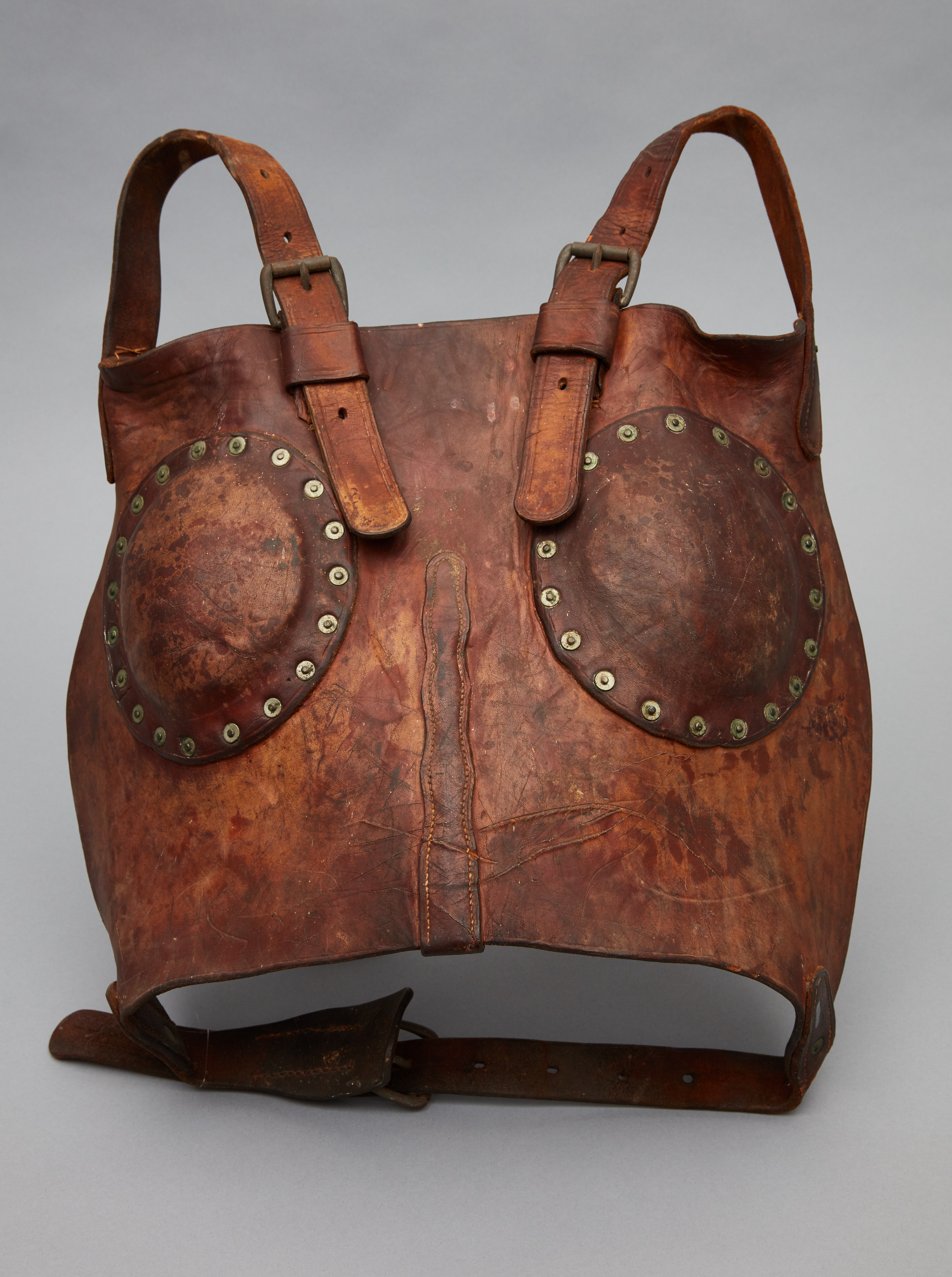 A brown leather bag with rivets on it.