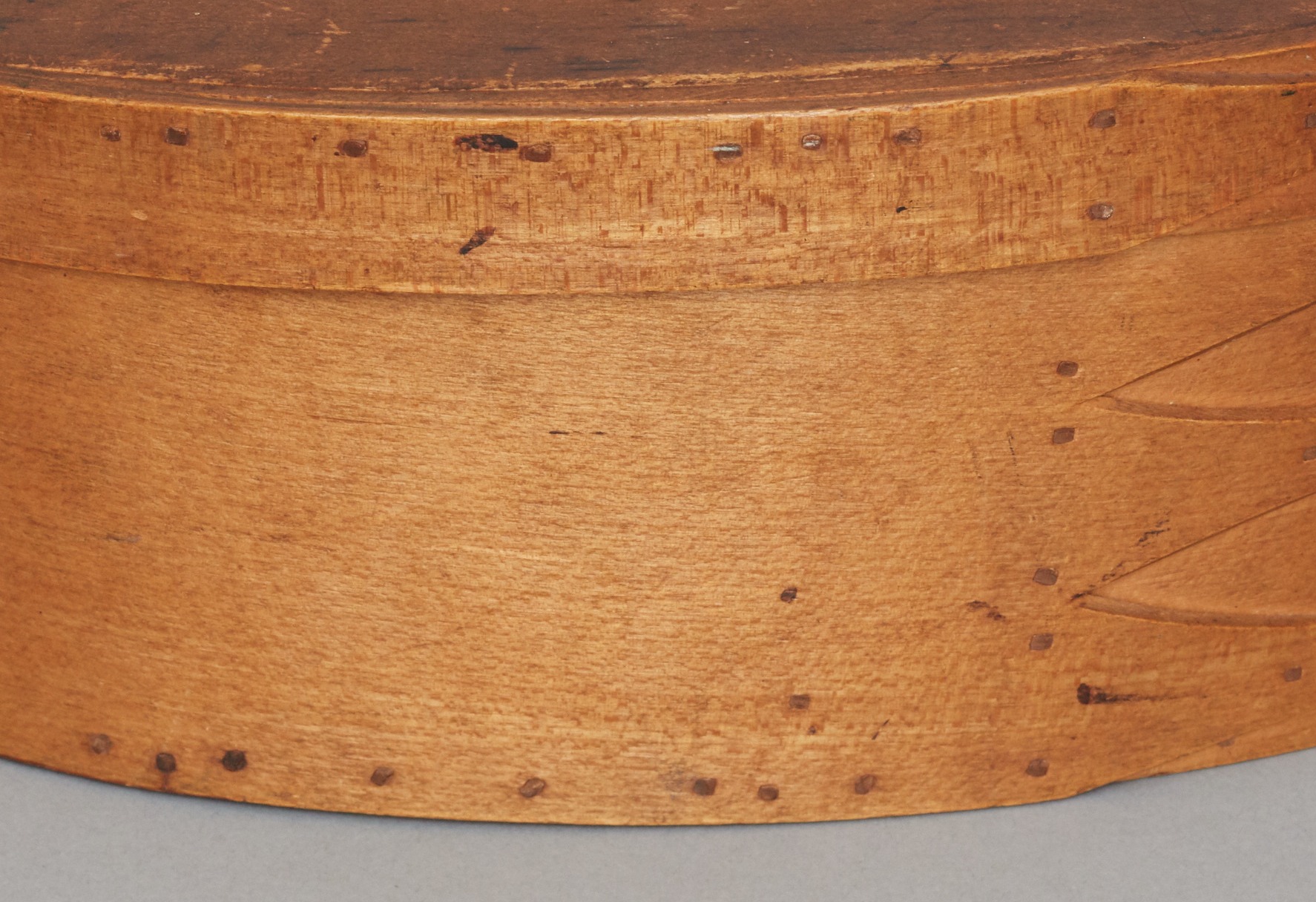 A wooden box with rivets on it.