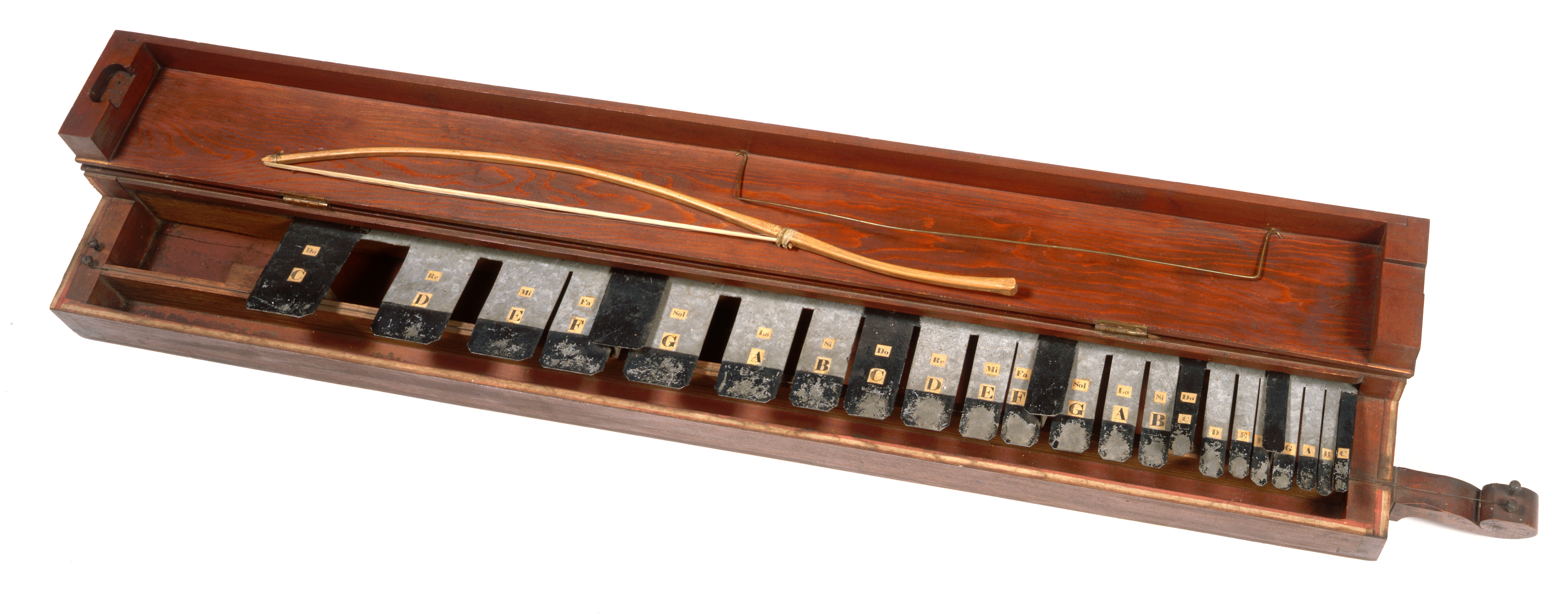 A wooden box containing a set of musical instruments.