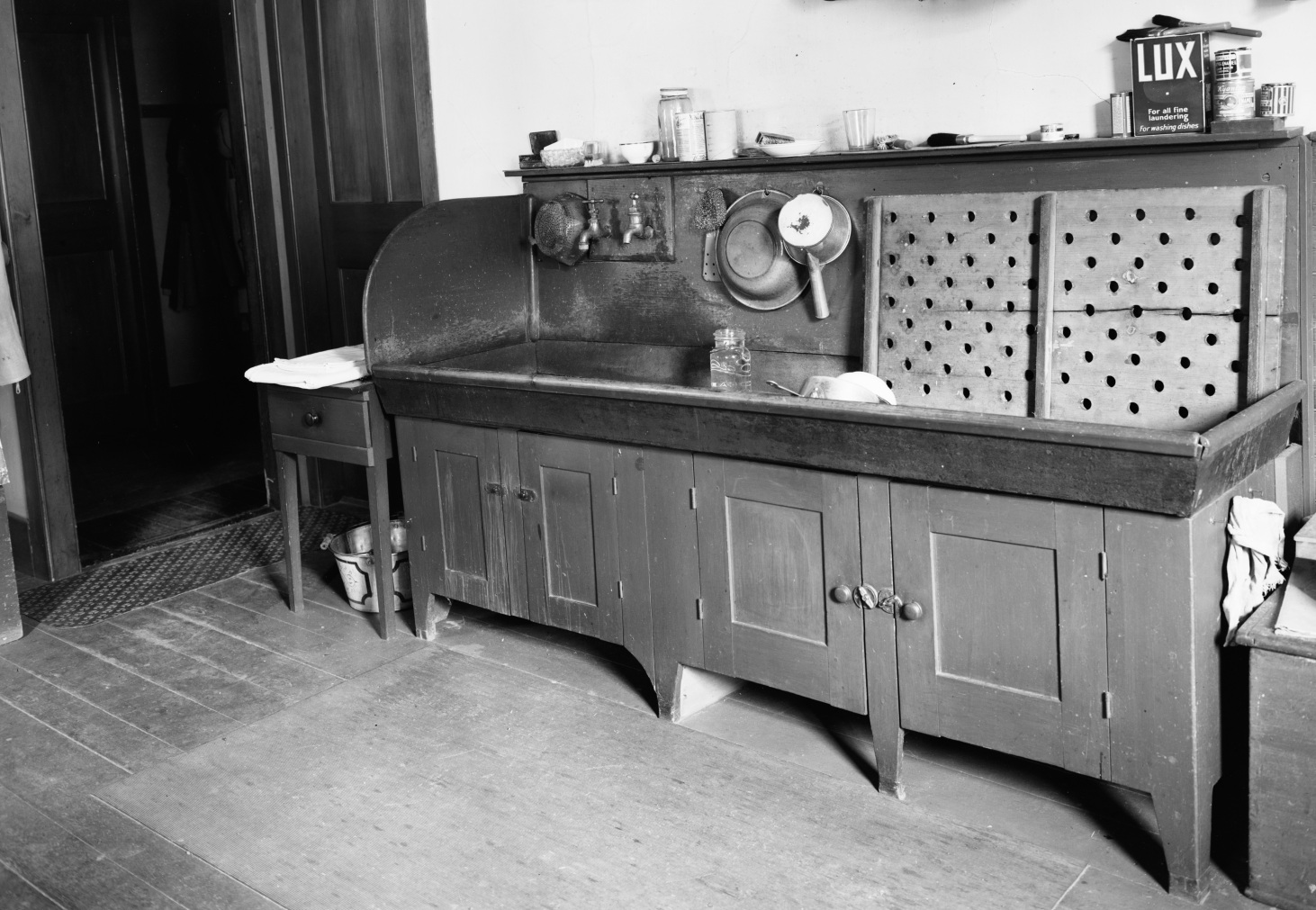 A black and white photo of an old kitchen.