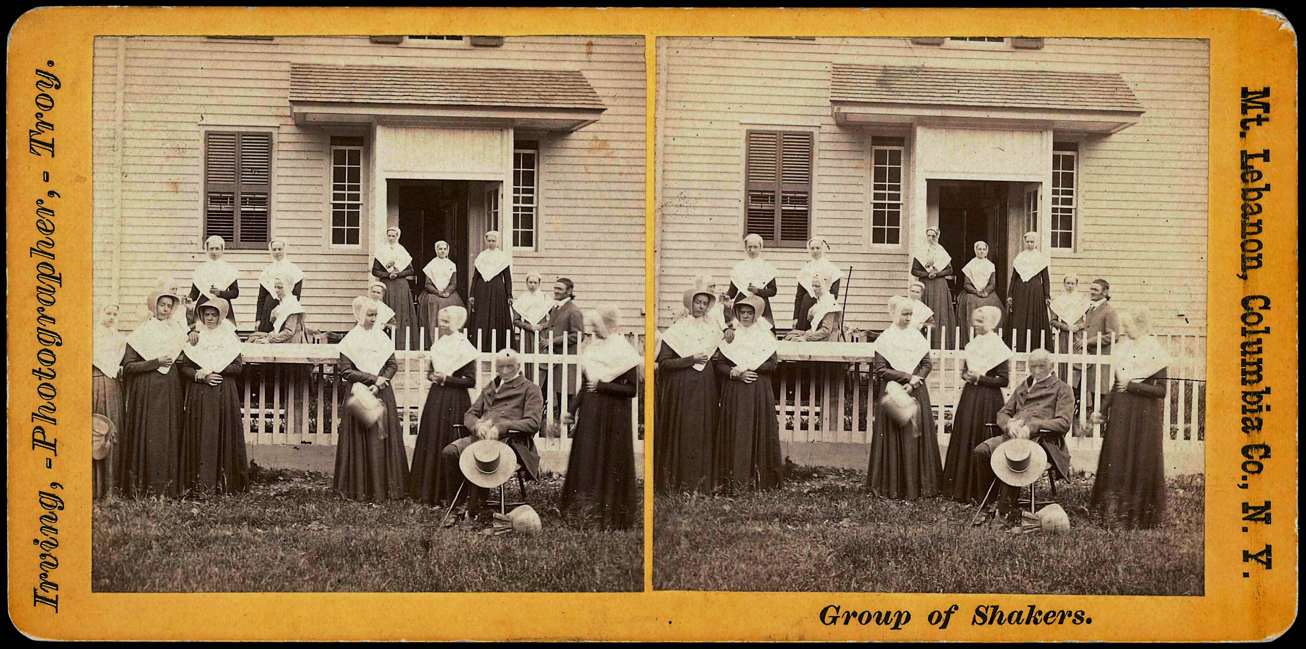 A photo of a group of women posing in front of a house.