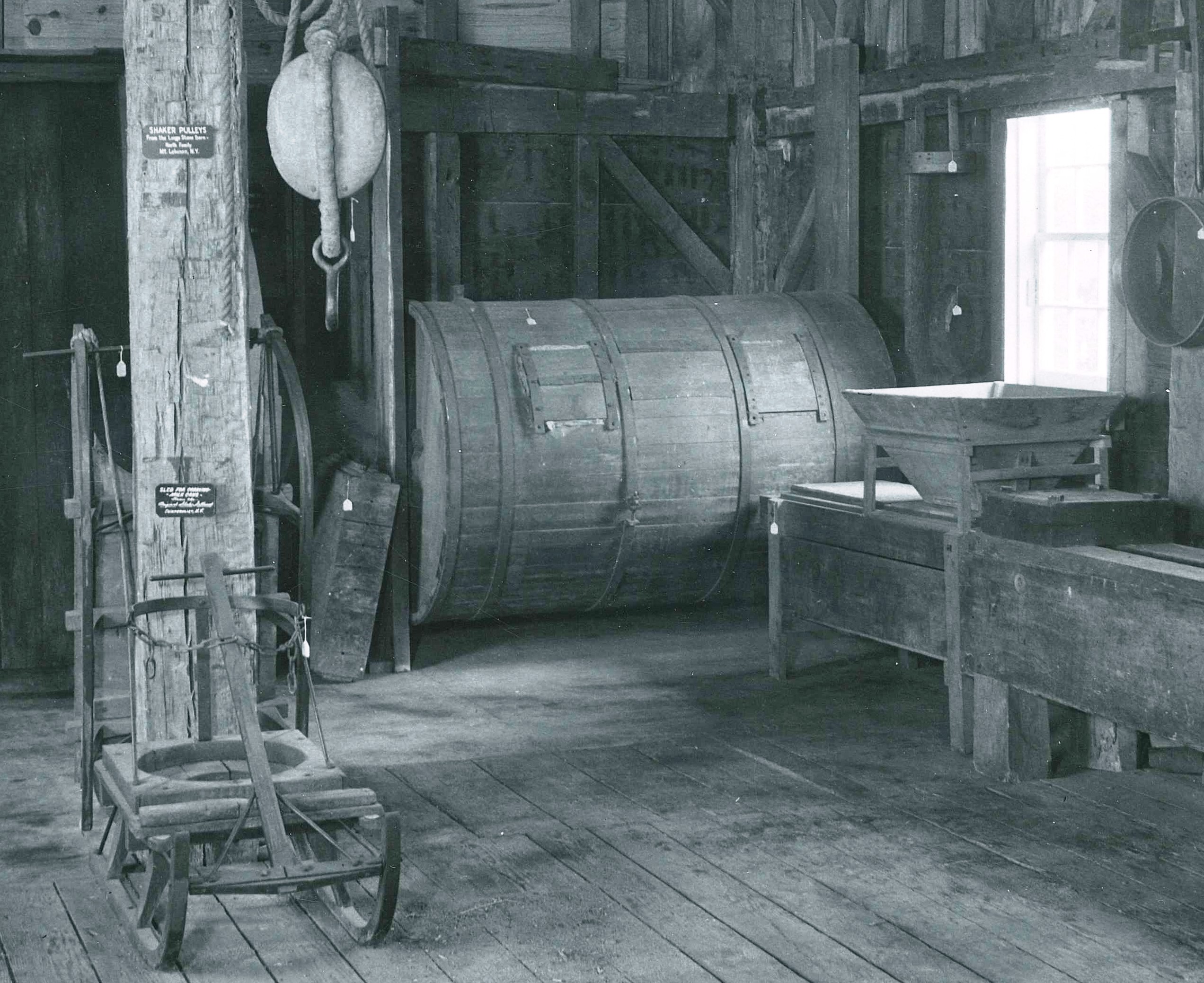 A black and white photo of an old barn.