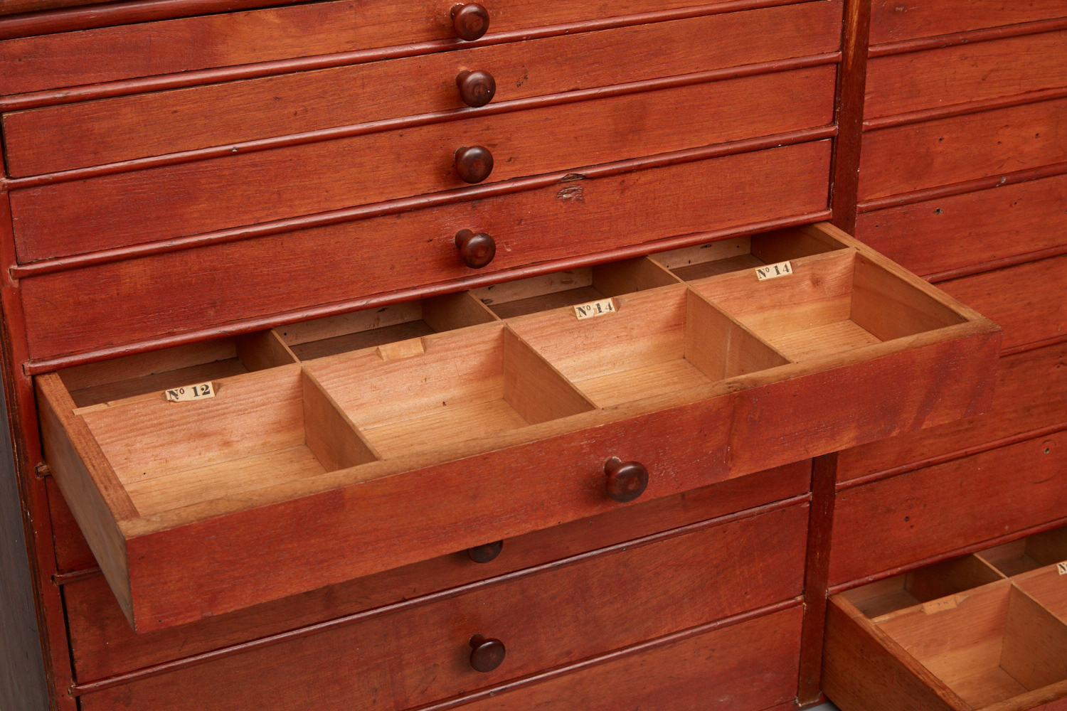 A wooden chest of drawers with several drawers.