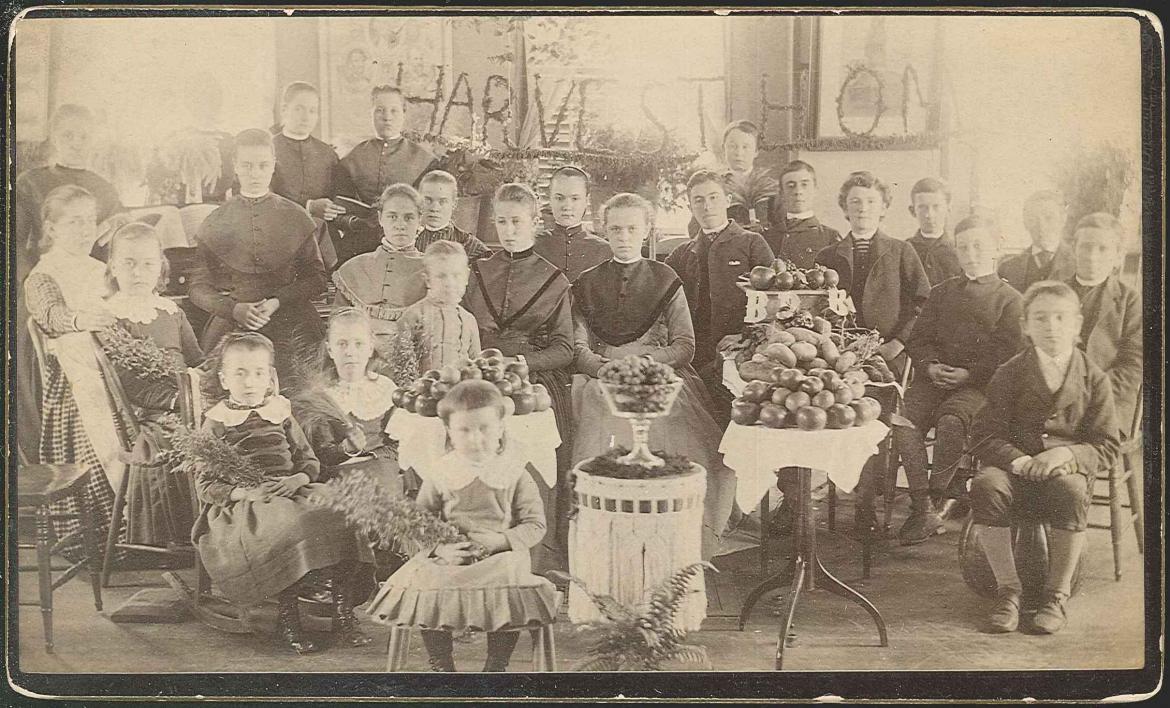 An old photo of a group of children posing for a picture.