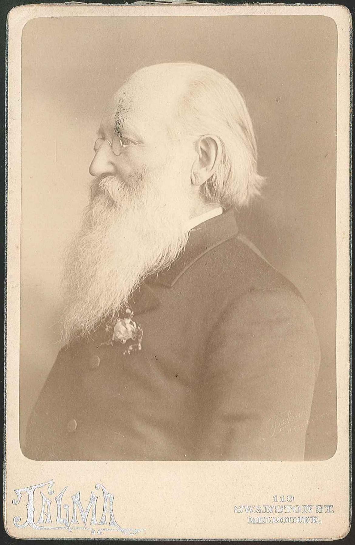 An old photograph of a man with a beard.