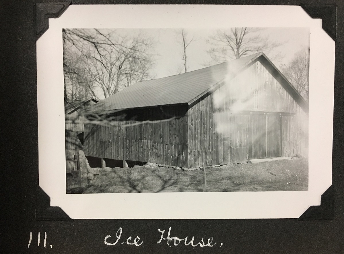 A black and white photograph of a barn.