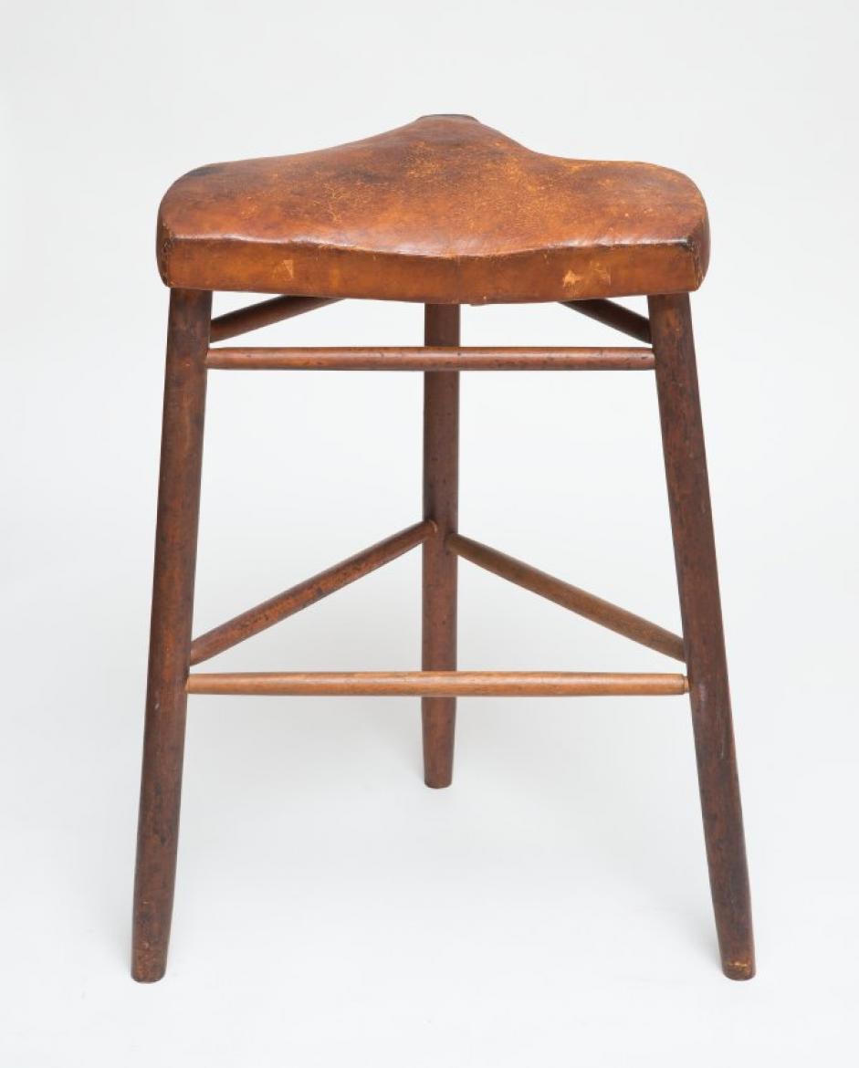 A small wooden stool with a wooden seat.